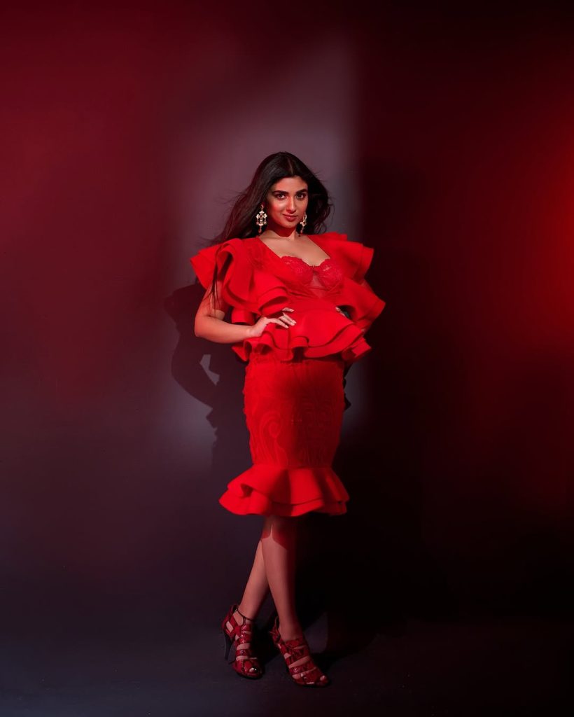 Striking crimson color creates dramatic impact against Pragya Nagra's neutral backdrop
