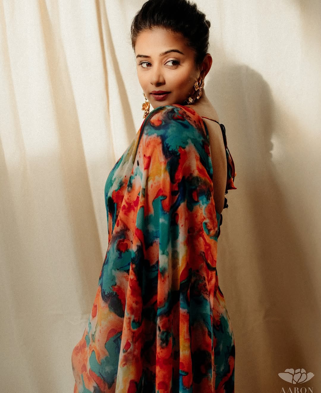 Vibrant multi-color patterns celebrate traditional textile artistry in Priyamani's saree
