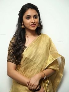 Priyanka Arul Mohan's facial features beautifully highlighted in golden saree portrait