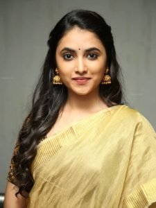 Priyanka Arul Mohan's facial features beautifully highlighted in golden saree portrait