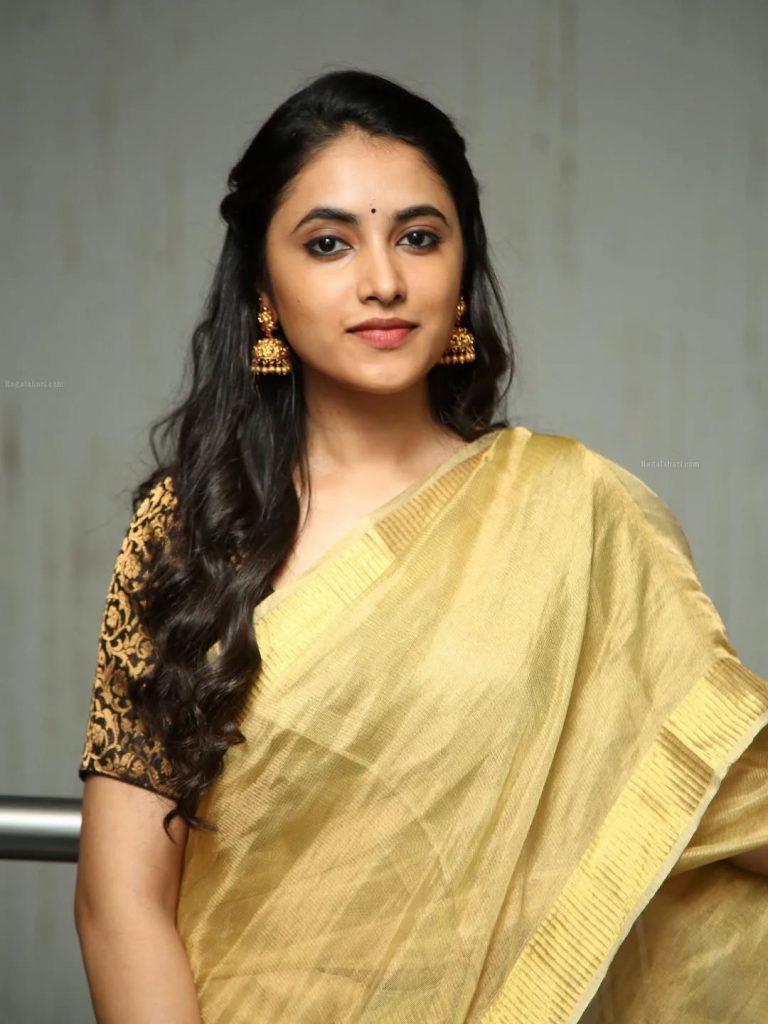Priyanka Arul Mohan's facial features beautifully highlighted in golden saree portrait