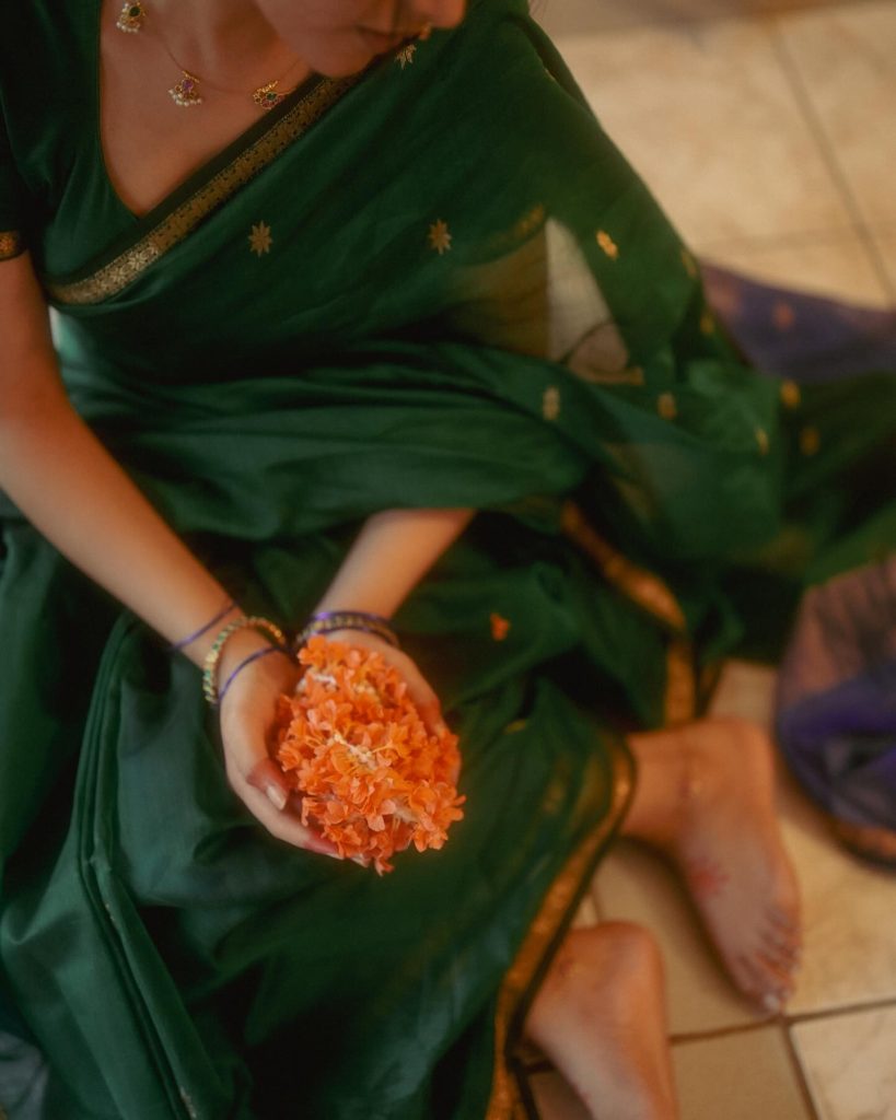 Emerald green saree fabric flows gracefully in Priyanka Mohan's elegant pose