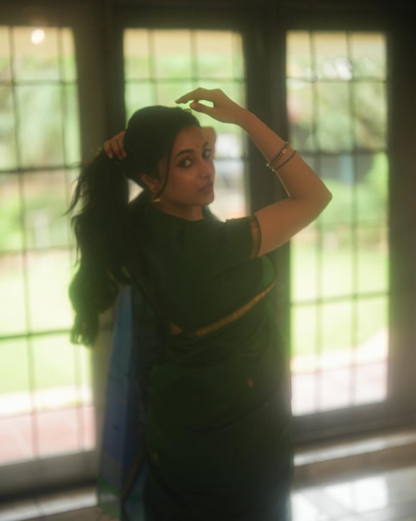 Emerald green saree fabric flows gracefully in Priyanka Mohan's elegant pose
