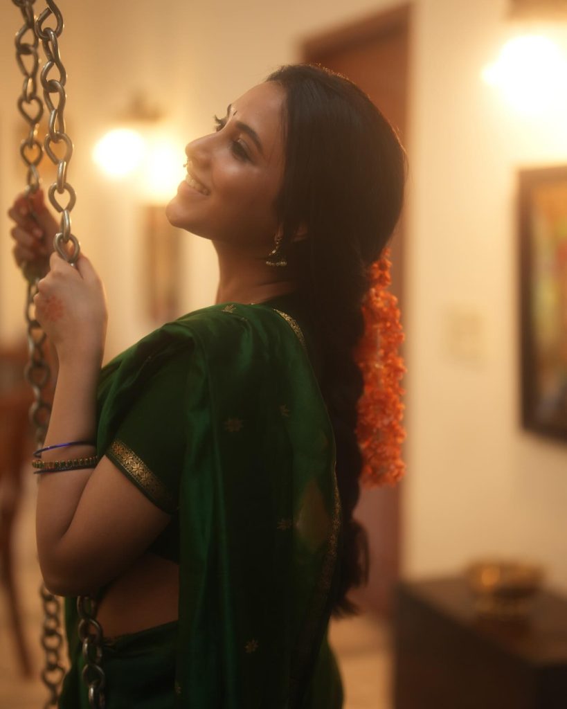 Emerald green saree fabric flows gracefully in Priyanka Mohan's elegant pose