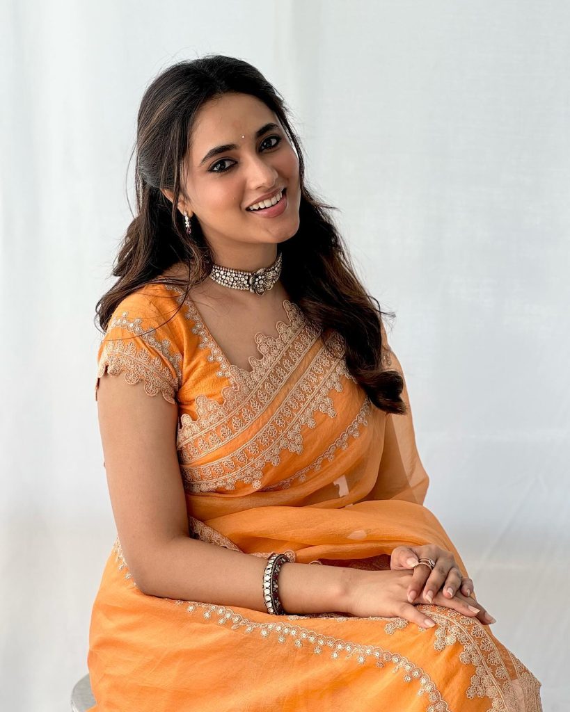 Brilliant orange saree creates dramatic visual impact in Priyanka Mohan's studio lighting