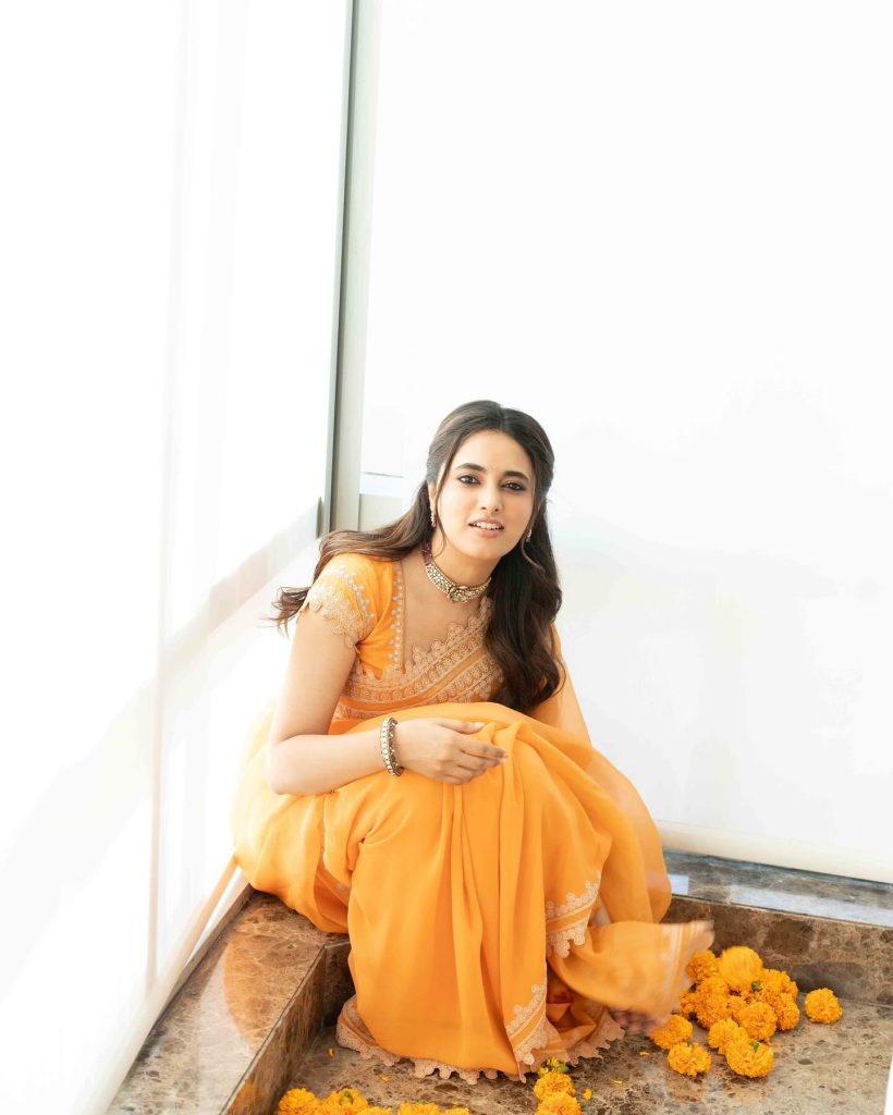 Brilliant orange saree creates dramatic visual impact in Priyanka Mohan's studio lighting