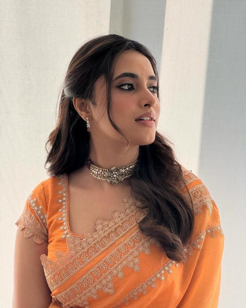 Brilliant orange saree creates dramatic visual impact in Priyanka Mohan's studio lighting