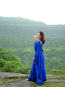 Priyanka Rewri embodies elegance in blue saree with lush greenery surroundings