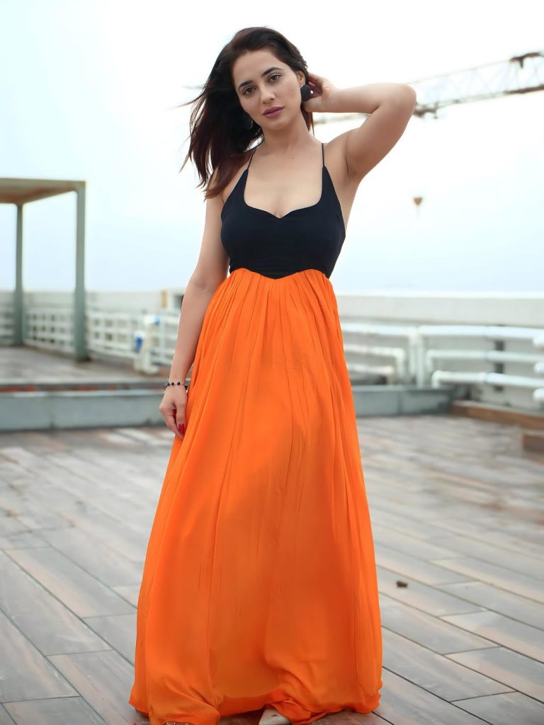 Bold black and orange dress creates striking visual impact for Priyanka Rewri