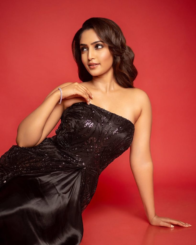 Glamour doll transformation showcased in Reba Monica John's black dress styling