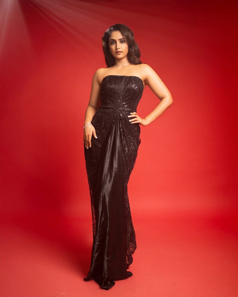 Reba Monica John embodies sophisticated elegance in striking black dress ensemble