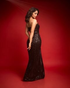 Glamour doll transformation showcased in Reba Monica John's black dress styling