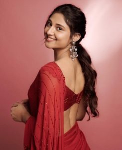 Traditional sheer red saree elegance showcased by Ritika Nayak with pearl jewelry