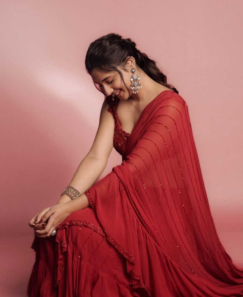 Elegant pearl jewelry complements Ritika Nayak's sheer red traditional styling