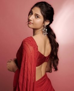 Elegant pearl jewelry complements Ritika Nayak's sheer red traditional styling