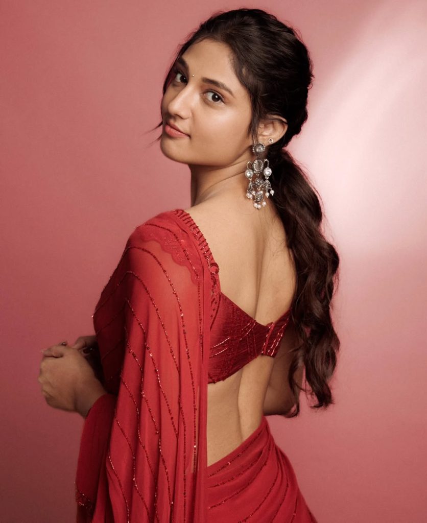 Elegant pearl jewelry complements Ritika Nayak's sheer red traditional styling