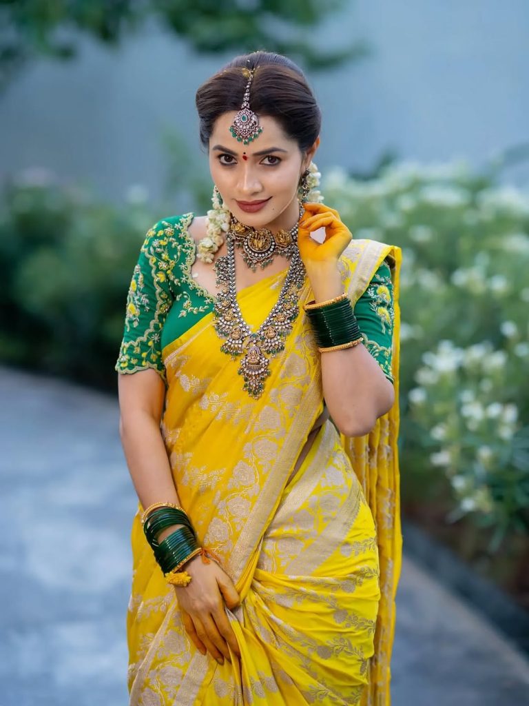 Vibrant yellow saree creates beautiful traditional elegance for Shobha Shetty