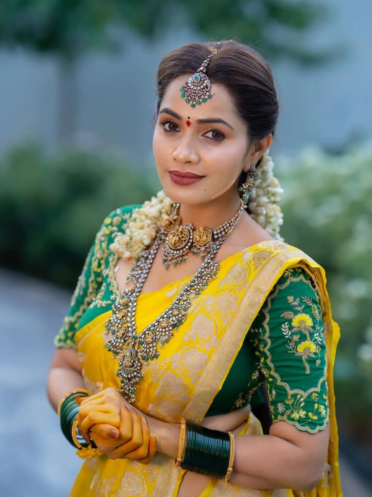 Vibrant yellow saree creates beautiful traditional elegance for Shobha Shetty
