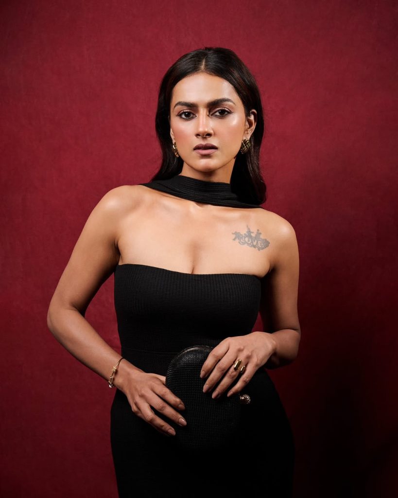 Minimal jewelry approach emphasizes Shraddha's tattoo and dress combination