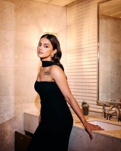 Minimal jewelry approach emphasizes Shraddha's tattoo and dress combination