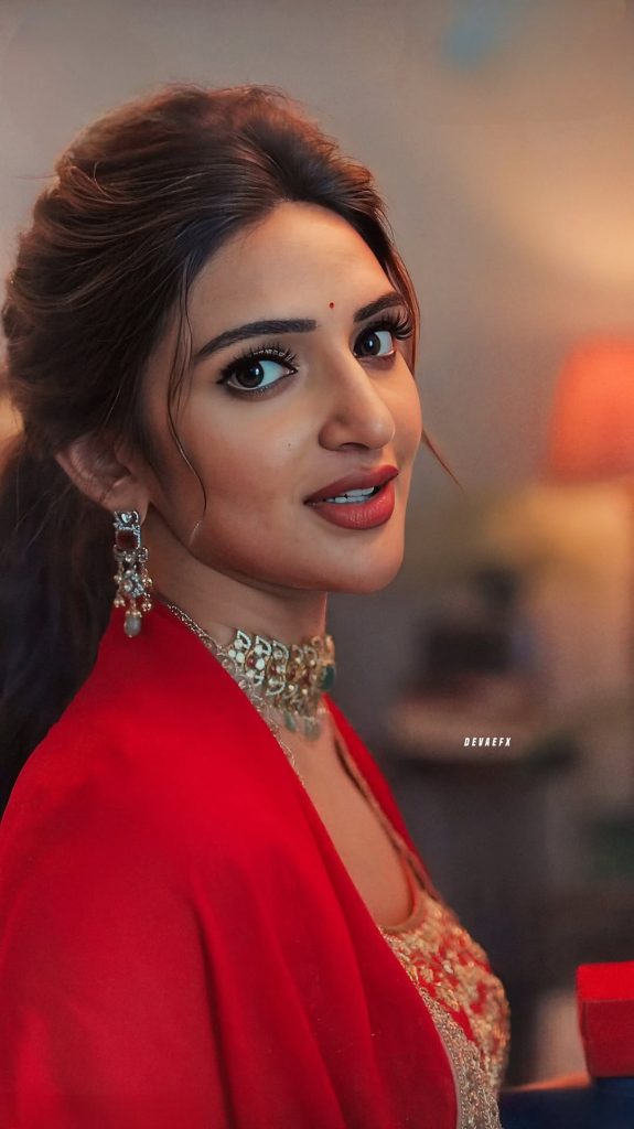 Red dress fabric texture creates rich backdrop for Sreeleela's closeup photography