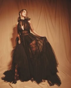 Black gown elegantly frames Tripti's moon-sun tattoo artistic expression