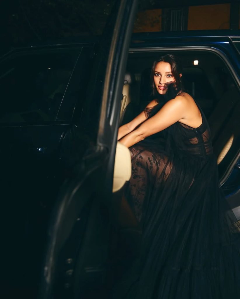 Black gown elegantly frames Tripti's moon-sun tattoo artistic expression