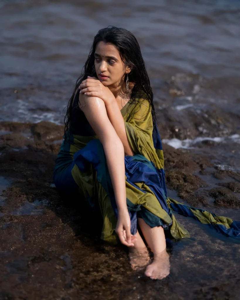 Beach sand contrasts beautifully with Trupti Ravindra's traditional saree fabric texture