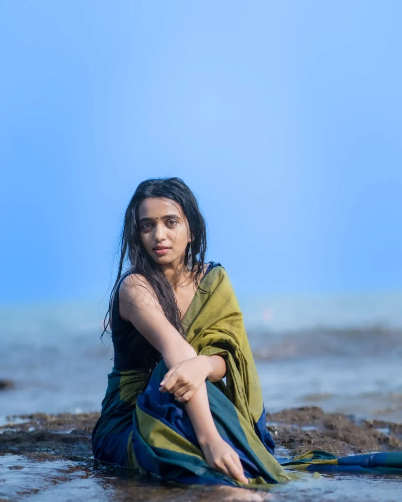 Beach sand contrasts beautifully with Trupti Ravindra's traditional saree fabric texture
