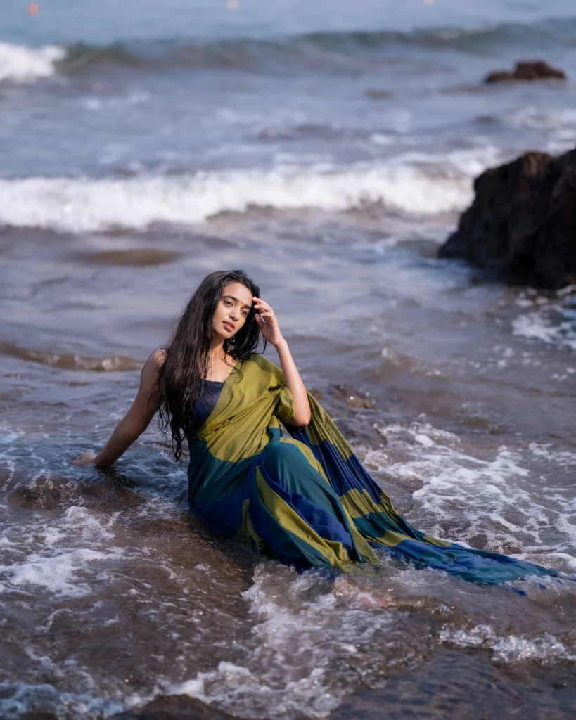 Beach sand contrasts beautifully with Trupti Ravindra's traditional saree fabric texture