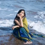 Beach sand contrasts beautifully with Trupti Ravindra's traditional saree fabric texture
