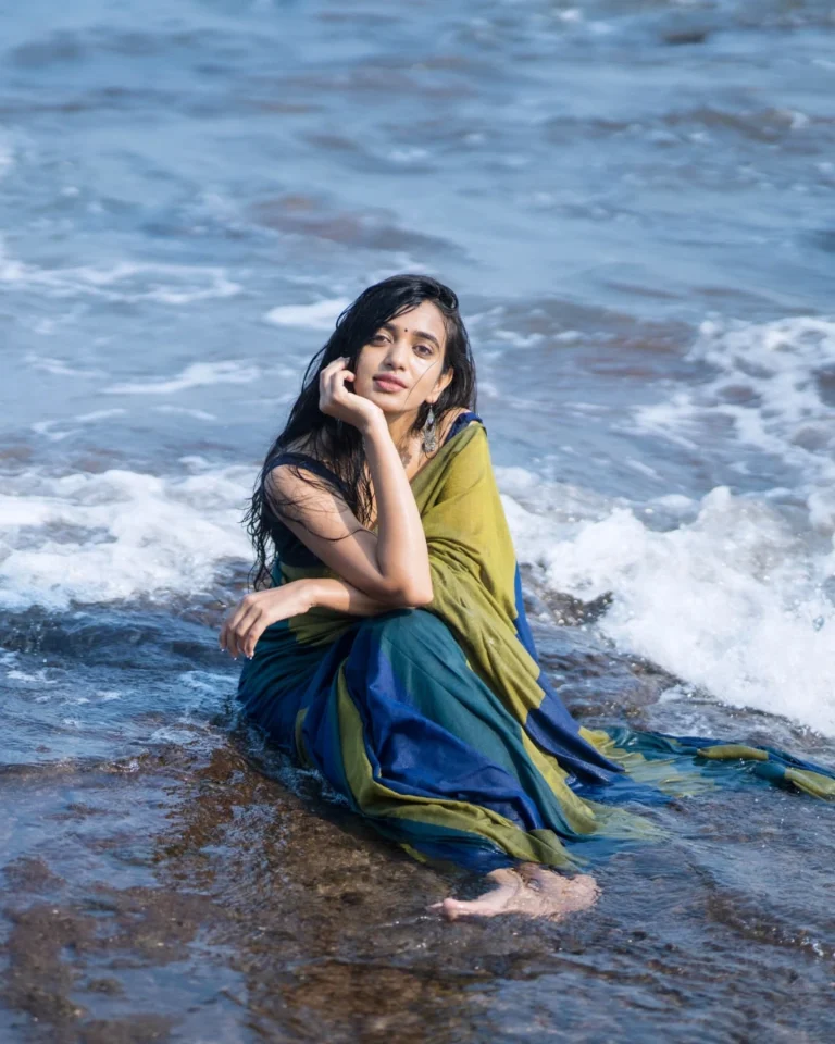 Beach sand contrasts beautifully with Trupti Ravindra's traditional saree fabric texture