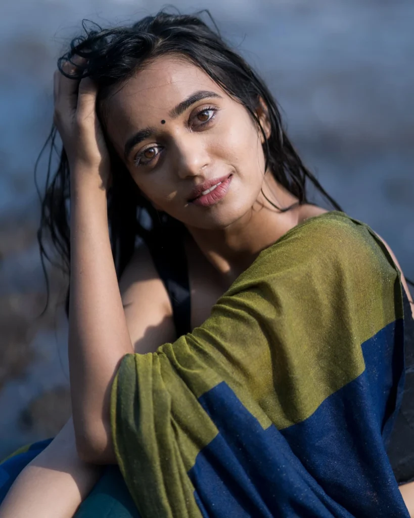 Beach sand contrasts beautifully with Trupti Ravindra's traditional saree fabric texture
