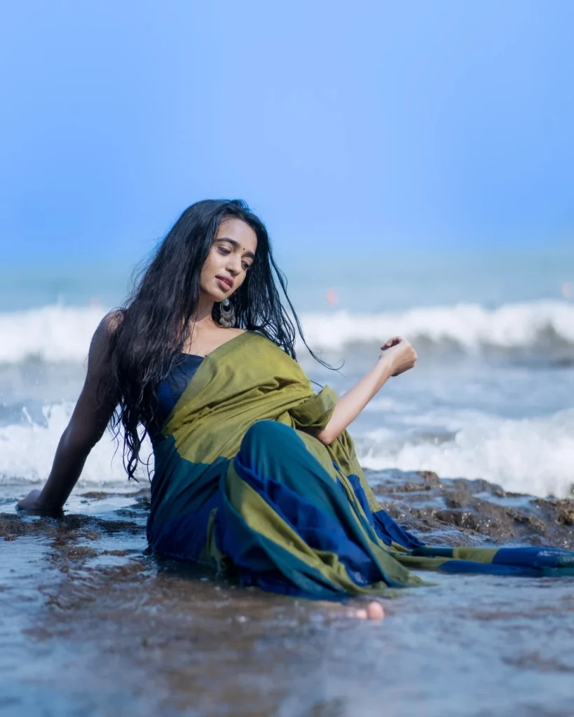 Beach sand contrasts beautifully with Trupti Ravindra's traditional saree fabric texture