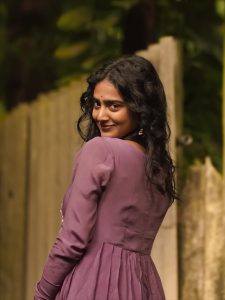 Purple pleated gown creates graceful movement in Yoga Lakshmi's outdoor photography