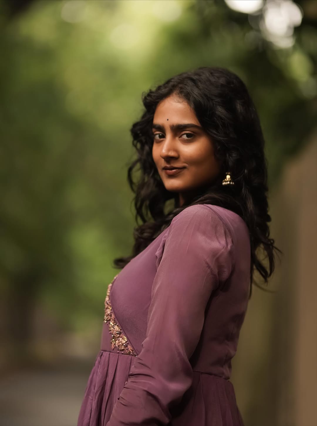 Purple pleated gown creates graceful movement in Yoga Lakshmi's outdoor photography