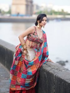 Ocean backdrop with Aarushi Baruah in colorful bandhani print saree