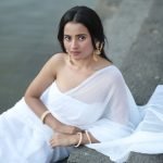 Serene portrait of Aarushi Baruah in white saree natural lake backdrop