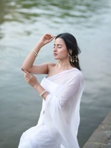 Aarushi Baruah peaceful expression in flowing white chiffon saree