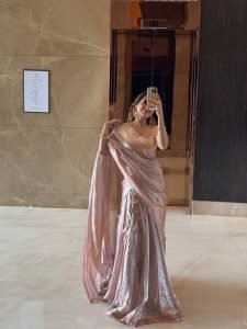 Lustrous silk fabric in Ashika Ranganath pink saree closeup