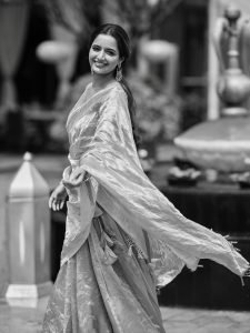 Lustrous silk fabric in Ashika Ranganath pink saree closeup