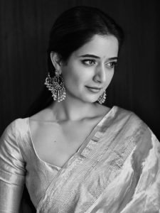 Ashika Ranganath graceful pose in traditional pink silk draping