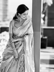 Ashika Ranganath graceful pose in traditional pink silk draping