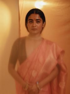 Warm glow lighting on Chaithra J Achar rose colored saree