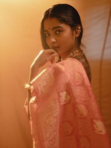 Warm glow lighting on Chaithra J Achar rose colored saree