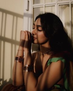 Deepti Sati contemplative expression in earthy colored silk saree