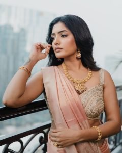 Sunlit balcony portrait of Eesha Rebba in traditional peach saree