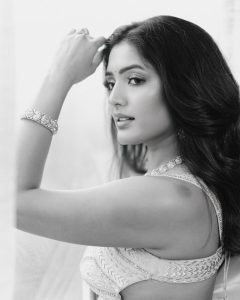 Sunlit balcony portrait of Eesha Rebba in traditional peach saree