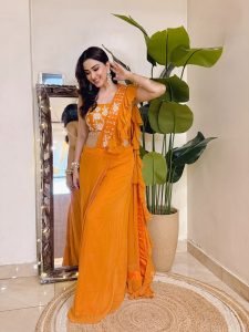 Indoor lighting highlighting Eshanya Maheshwari orange ruffle saree texture