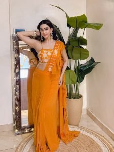Modern ruffle detailing on Eshanya Maheshwari orange saree closeup